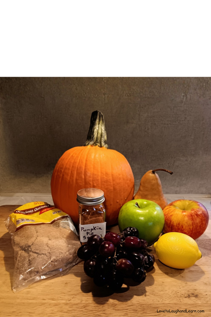 Ingredients for Fall Harvest Fruit Salad including raw pumpkin, apples, pear, grapes, lemon, brown sugar, and pumpkin pie spice.